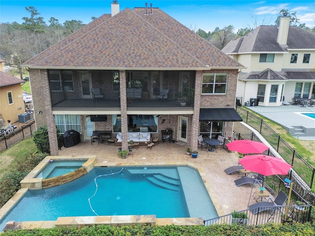 back of house with a fenced backyard, a patio, and brick siding