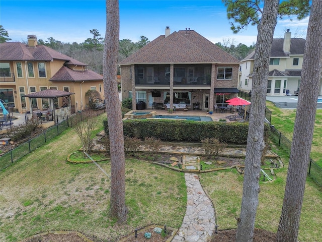 rear view of property with a patio area, a fenced backyard, a lawn, and brick siding