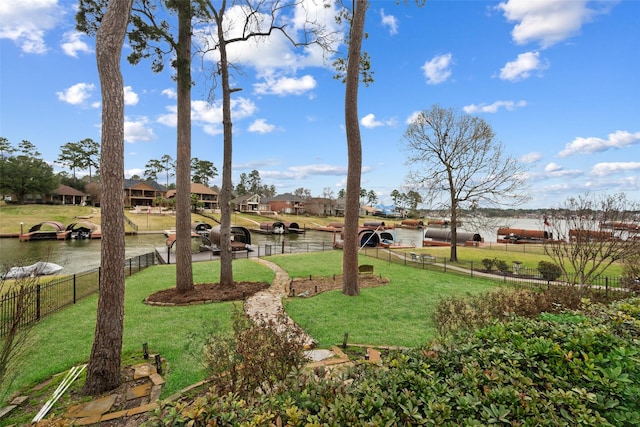 view of yard featuring a water view and fence