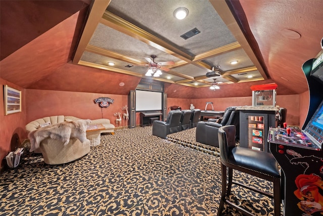 home theater room featuring a textured ceiling, ceiling fan, carpet floors, coffered ceiling, and visible vents