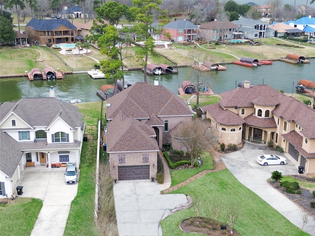 birds eye view of property featuring a water view and a residential view