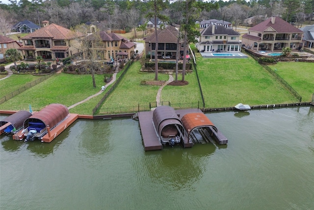 view of dock featuring a residential view, an outdoor pool, a water view, and a yard