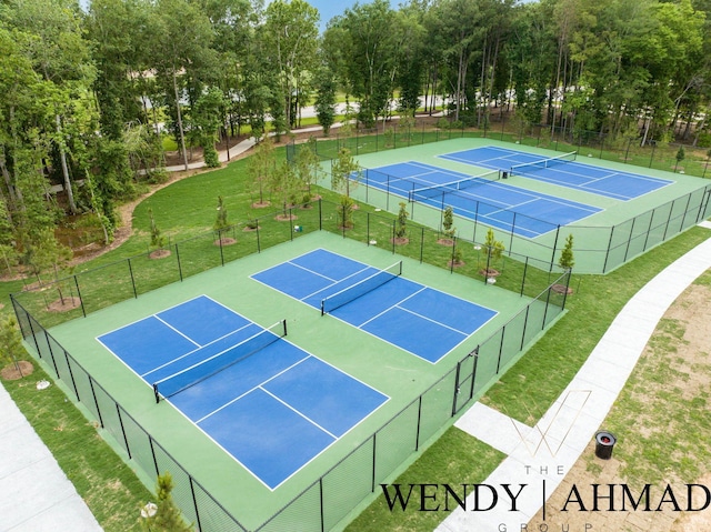 view of sport court featuring fence and a yard