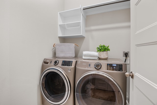 clothes washing area featuring laundry area and separate washer and dryer