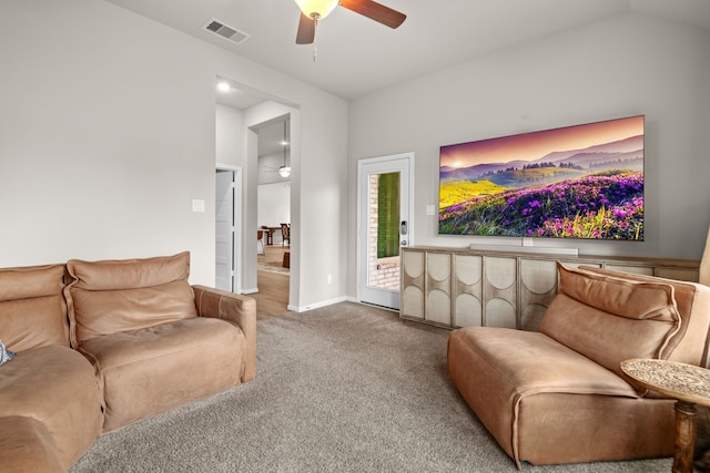 living area featuring baseboards, visible vents, lofted ceiling, ceiling fan, and carpet flooring