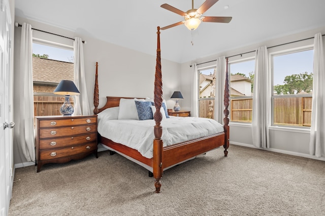 bedroom featuring carpet floors, lofted ceiling, baseboards, and a ceiling fan