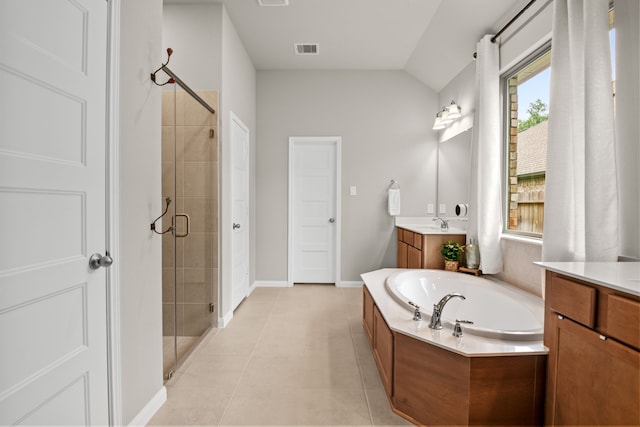 bathroom featuring a stall shower, visible vents, a garden tub, tile patterned flooring, and vanity