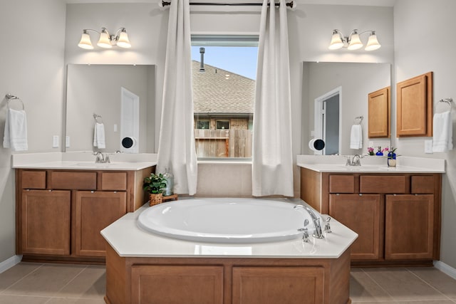 full bathroom with a sink, a garden tub, tile patterned flooring, and two vanities