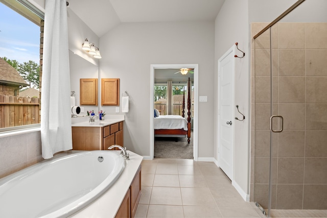 full bathroom featuring lofted ceiling, a garden tub, tile patterned flooring, connected bathroom, and a shower stall