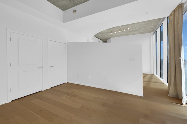 spare room featuring wood finished floors