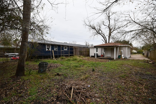 back of property featuring fence