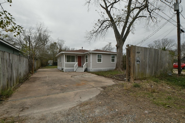 bungalow-style house with fence