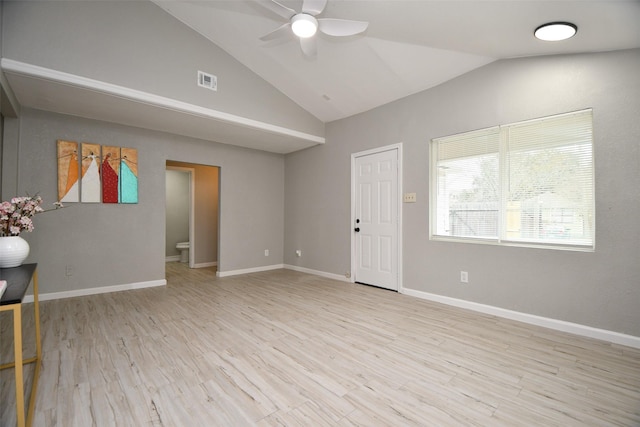 unfurnished room featuring lofted ceiling, light wood-style flooring, visible vents, and baseboards