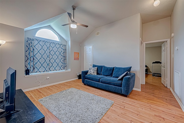 living area featuring a ceiling fan, baseboards, visible vents, and light wood finished floors