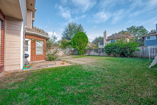 view of yard featuring a patio area and a fenced backyard