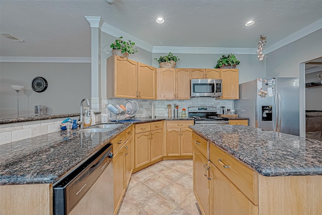 kitchen featuring visible vents, stainless steel appliances, a sink, and light brown cabinetry