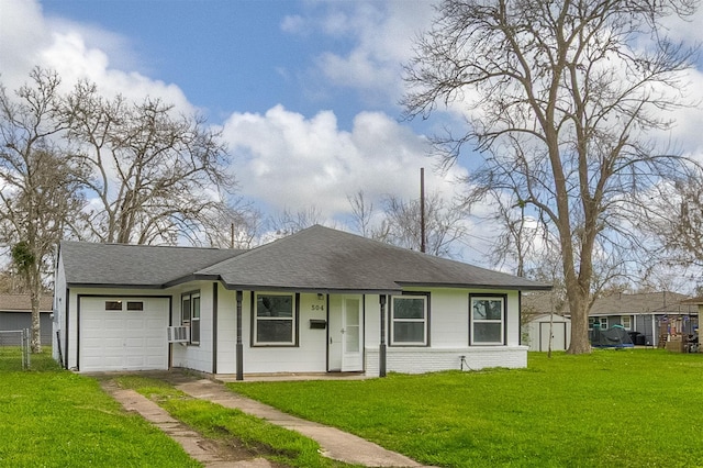 view of front of house featuring driveway, a garage, a shingled roof, a storage unit, and a front lawn