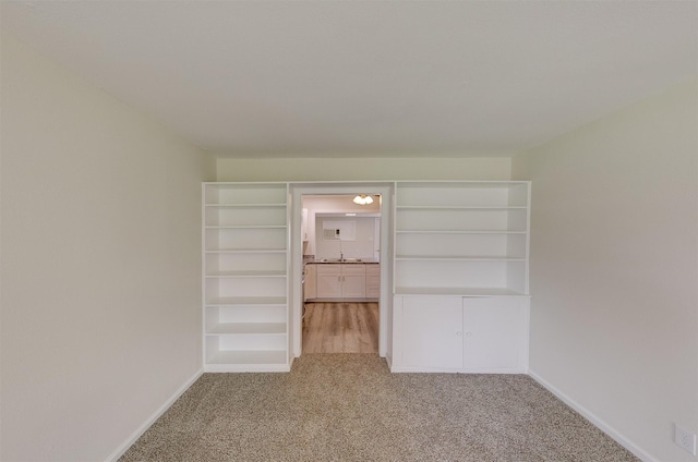 unfurnished bedroom with light carpet and baseboards