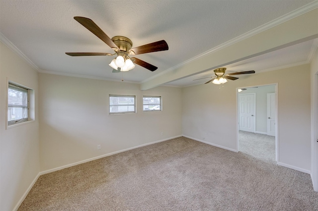 unfurnished room featuring ornamental molding, light colored carpet, a textured ceiling, and baseboards