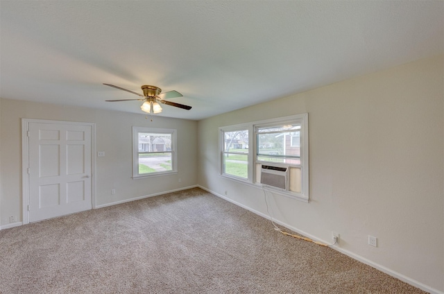 carpeted spare room with cooling unit and baseboards