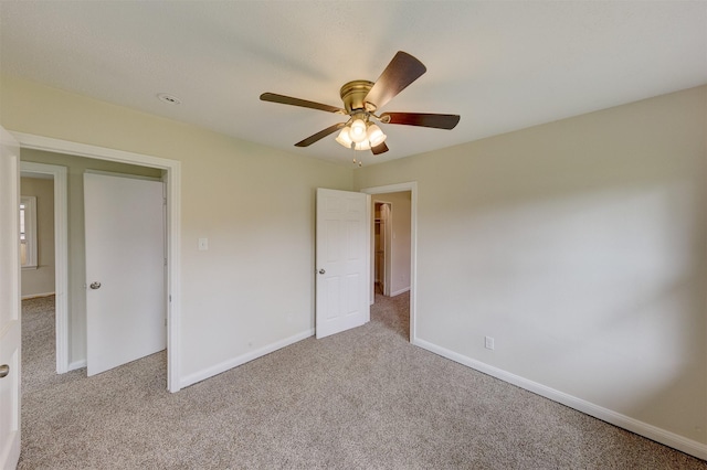 unfurnished bedroom with carpet, baseboards, and ceiling fan