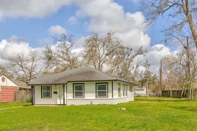 504 Elm St, Lake Jackson, TX 77566 - rear view of property featuring brick siding, a lawn, a shingled roof, and fence