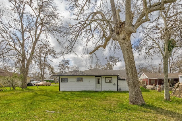 view of front of property with a front yard and fence