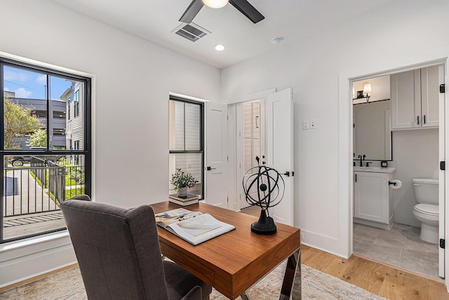 office space with light wood finished floors, visible vents, baseboards, ceiling fan, and recessed lighting