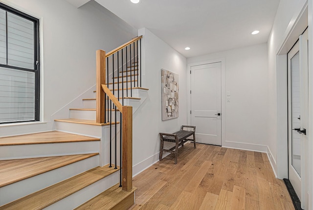 interior space with baseboards, wood finished floors, and recessed lighting