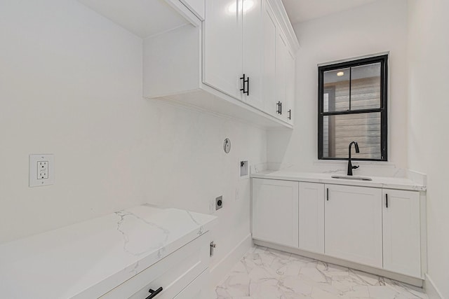 laundry room featuring a sink, baseboards, marble finish floor, cabinet space, and electric dryer hookup