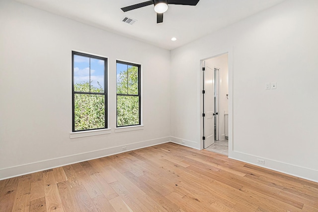 empty room with recessed lighting, visible vents, light wood-style floors, a ceiling fan, and baseboards