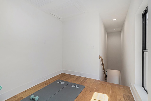 exercise room featuring recessed lighting, baseboards, and wood finished floors