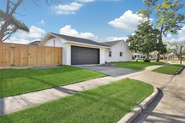 view of front of home featuring concrete driveway, fence, a garage, and a front yard