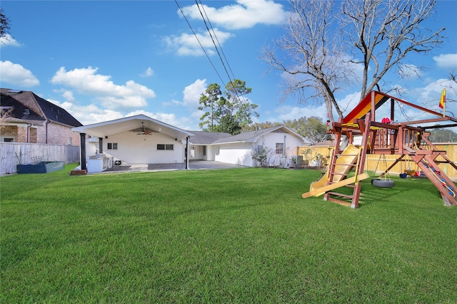 view of yard featuring a patio, a ceiling fan, a playground, and a fenced backyard