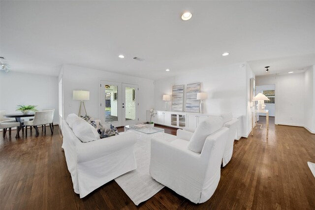 living area featuring recessed lighting, wood finished floors, visible vents, and french doors