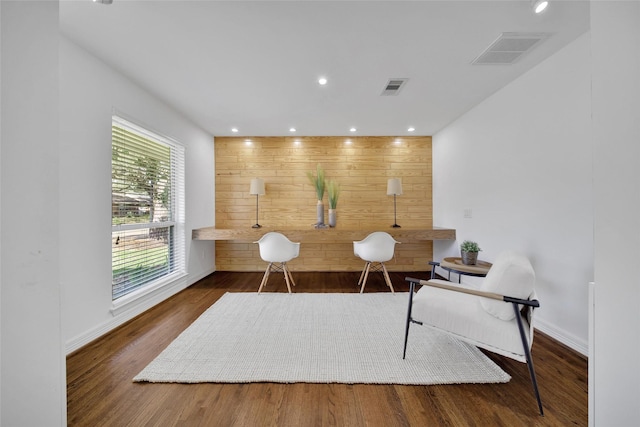 home office featuring recessed lighting, visible vents, wooden walls, and wood finished floors