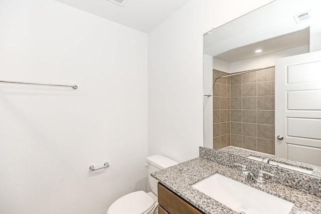 full bath with a shower, visible vents, vanity, and toilet