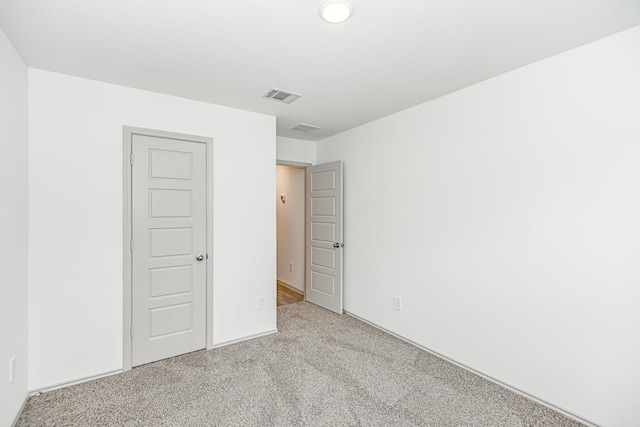 unfurnished bedroom featuring visible vents and carpet flooring