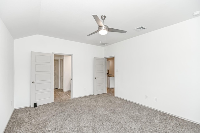 unfurnished bedroom with lofted ceiling, visible vents, ceiling fan, and carpet flooring