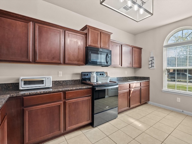 kitchen featuring baseboards, a toaster, black appliances, and light tile patterned flooring