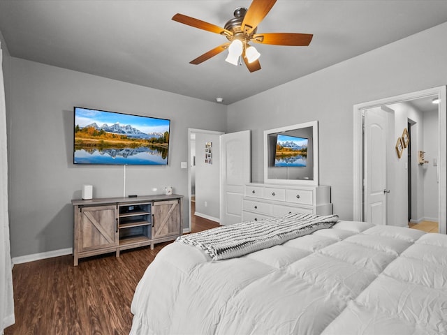 bedroom featuring ceiling fan, baseboards, and dark wood-type flooring