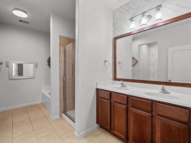 bathroom with a stall shower, a sink, visible vents, and tile patterned floors