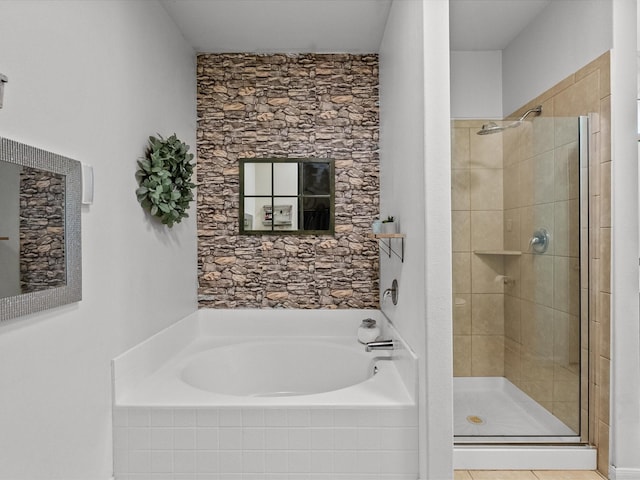 bathroom with a shower stall and a bath