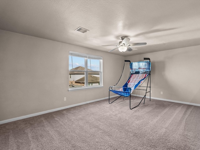 interior space featuring carpet floors, visible vents, ceiling fan, and baseboards