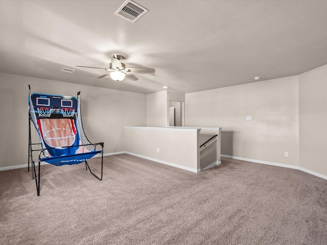 sitting room featuring an upstairs landing, baseboards, visible vents, and carpet flooring