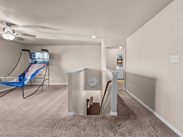 recreation room with a ceiling fan, washer / clothes dryer, carpet flooring, and baseboards