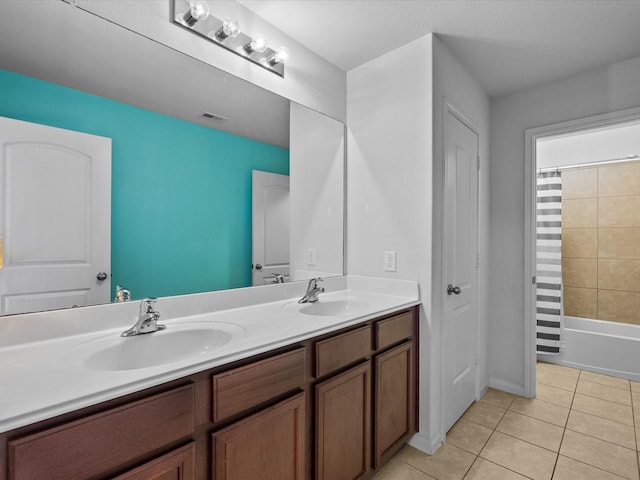 full bath featuring double vanity, a sink, visible vents, and tile patterned floors