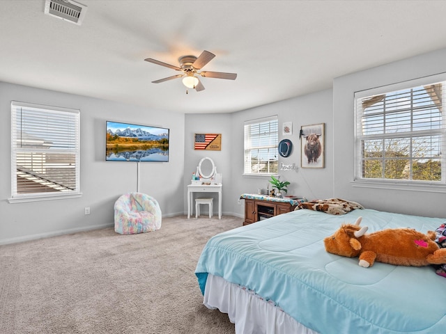 carpeted bedroom with baseboards, visible vents, and ceiling fan