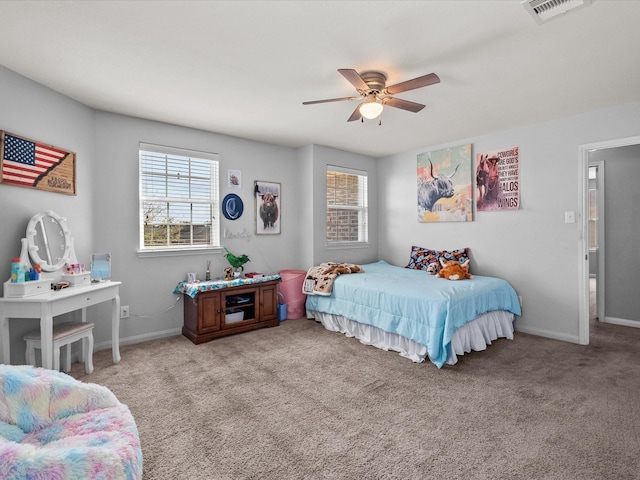 bedroom with carpet floors, baseboards, visible vents, and ceiling fan