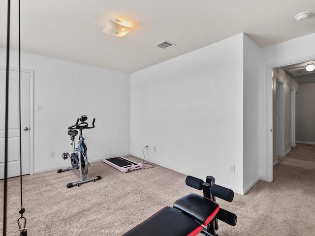 exercise room featuring baseboards, visible vents, and carpet flooring